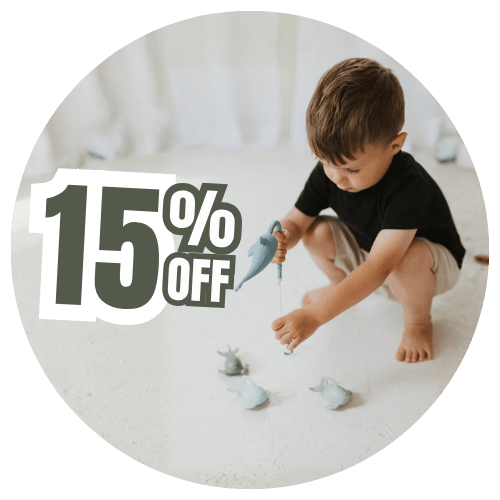Child playing with toy fish on a white surface with a 15% off text overlay.