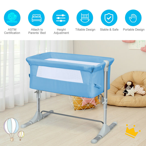 Portable baby bed side sleeper bassinet crib with carrying bag, angled view for travel convenience.