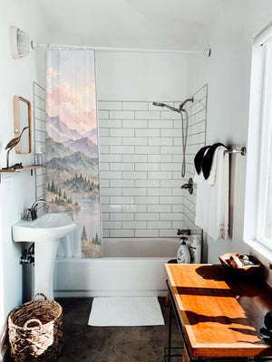 Lavender Peaks Rainbow shower curtain hanging on the rod over a white bathtub
