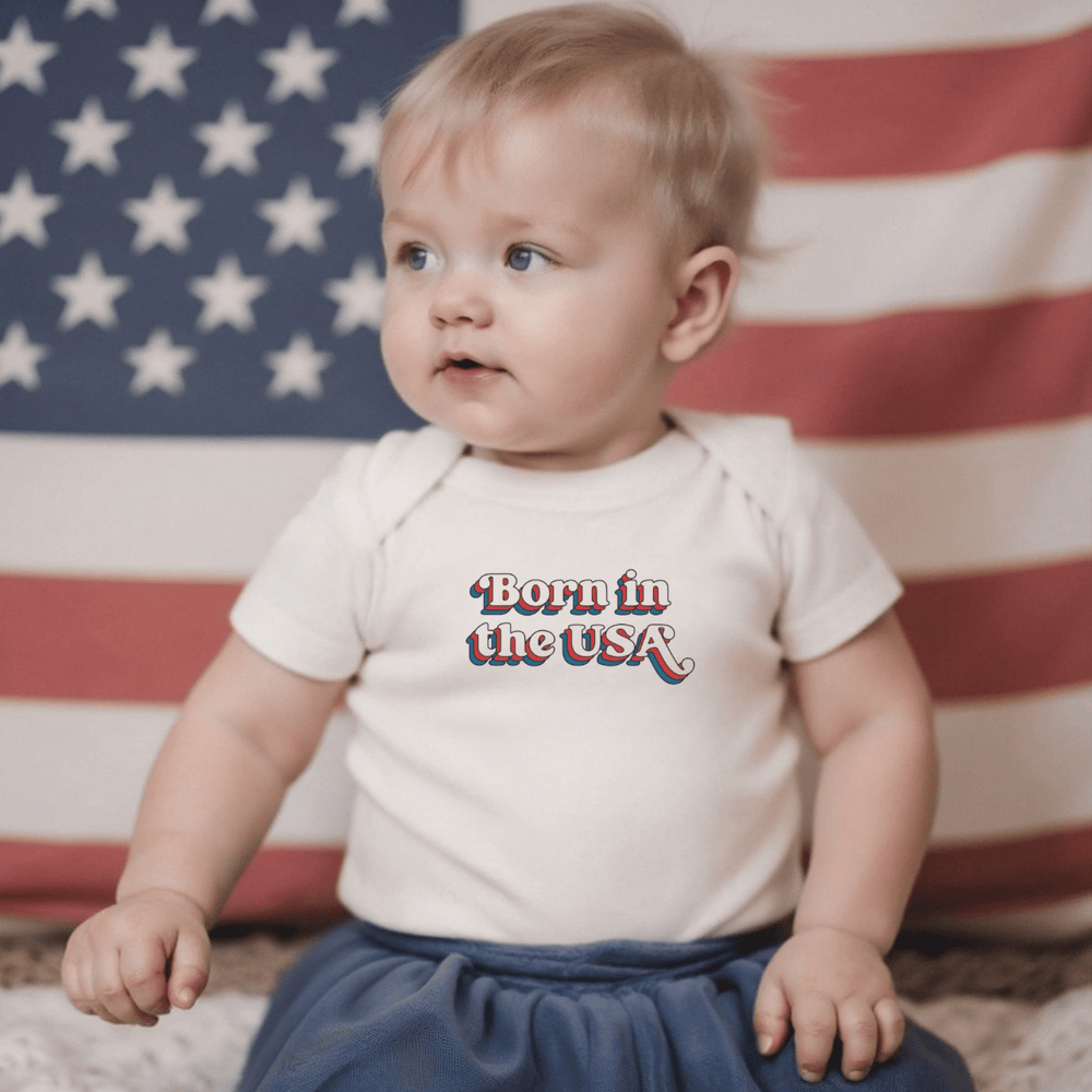 Graphic short sleeve bodysuit for babies, featuring "Born in the USA" design. Perfect for stylish little ones.
