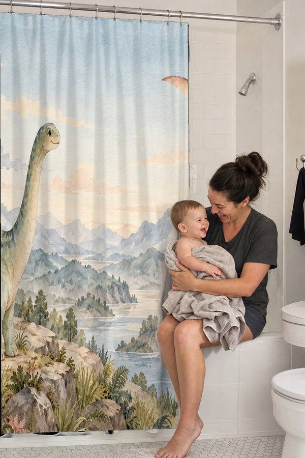 Mom holding her baby on the tub edge next to the Mountain Dinosaur shower curtain