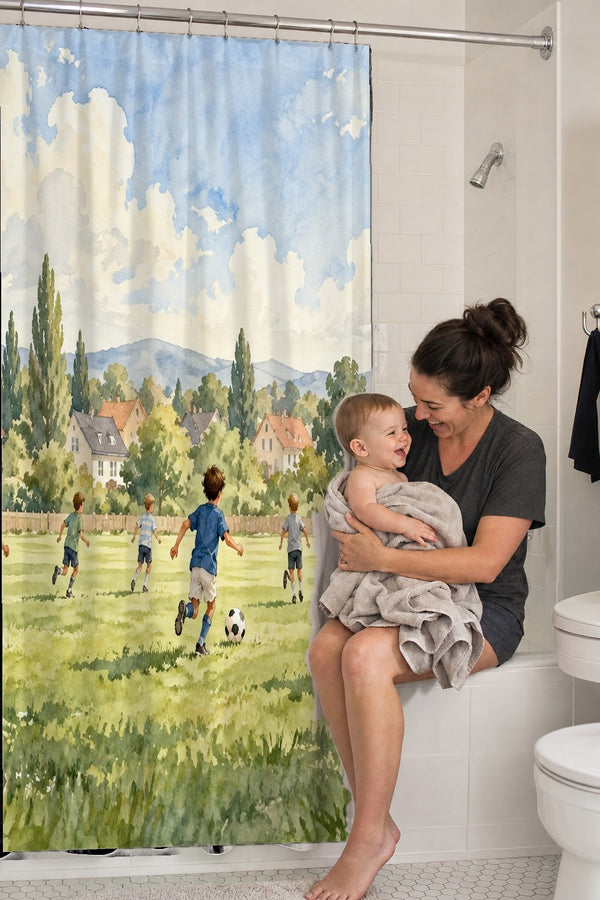 Mom holding her baby on the tub edge next to the Kids Playing Soccer shower curtain