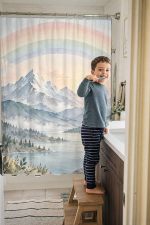 Child brushing teeth in a family bathroom with the Sunrise Lake Rainbow shower curtain