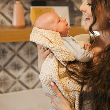 Soft macadamia knitted swaddle blanket for babies, perfect for cozy naps and stylish comfort.