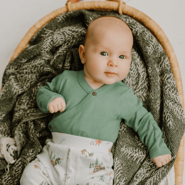 Basil Green short sleeve long bodysuit for babies, angle view 4 showcasing soft fabric and stylish design.
