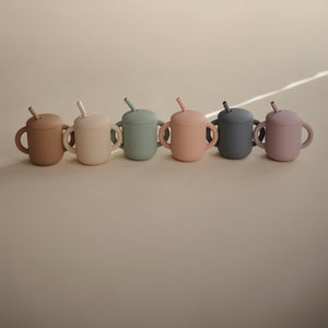 Silicone training cup with straw at angle 69, perfect for toddlers transitioning to independent drinking.