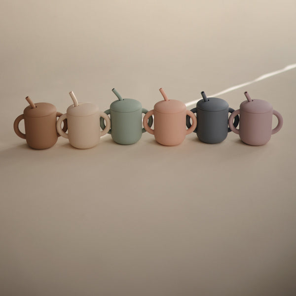 Silicone training cup with straw at angle 69, perfect for toddlers transitioning to independent drinking.