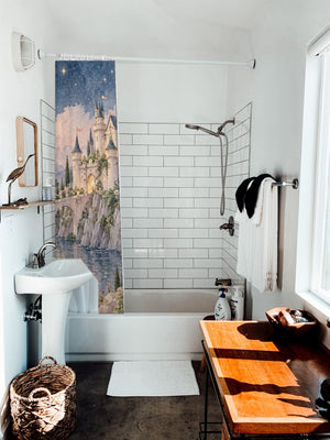 Moonlit Castle Fairy Tale shower curtain hanging on the rod over a white bathtub