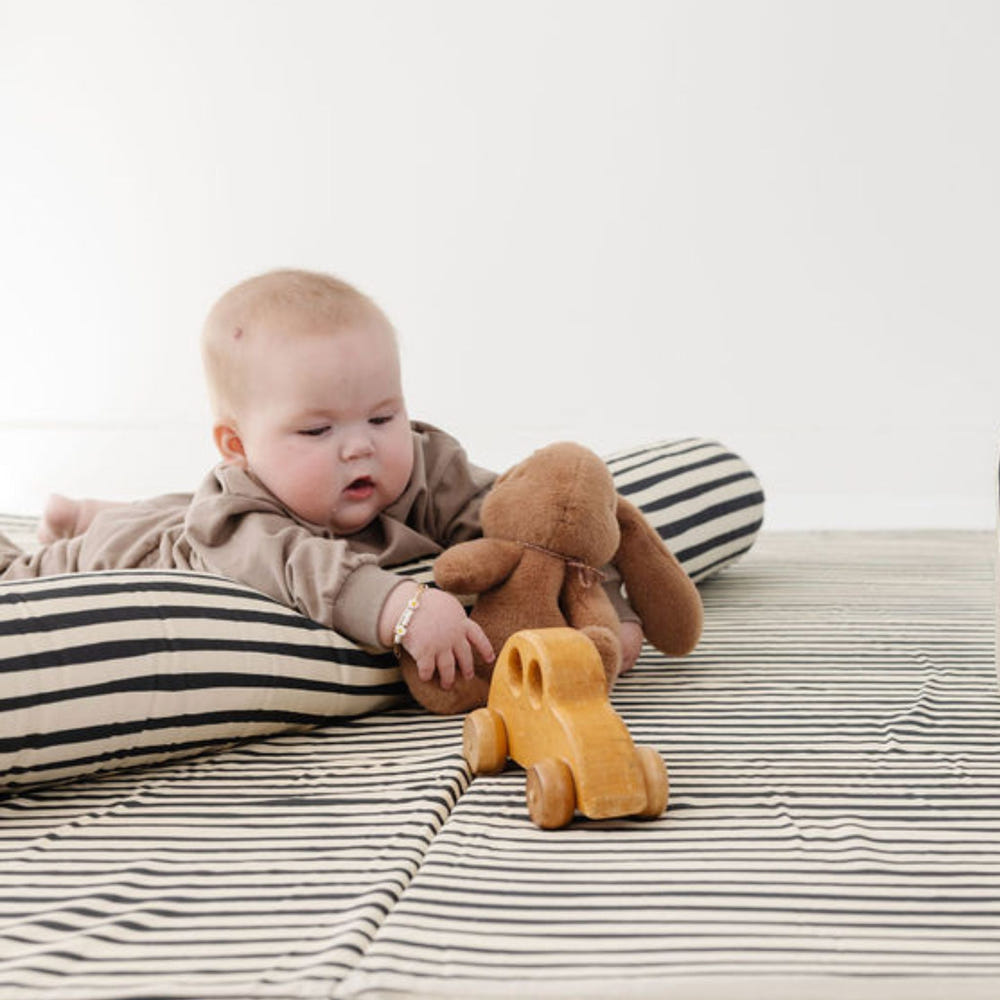 Bold Stripe Support Pillow for nursing, providing comfort and support for moms and babies during feeding sessions.