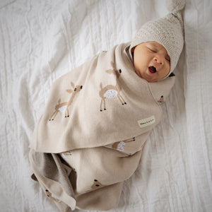 Luxury cotton deer knit swaddle baby blanket in soft colors, perfect for cozying up your little one.
