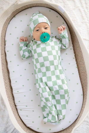 Sage knotted gown set for babies, featuring soft fabric and a stylish design, displayed at an angle.