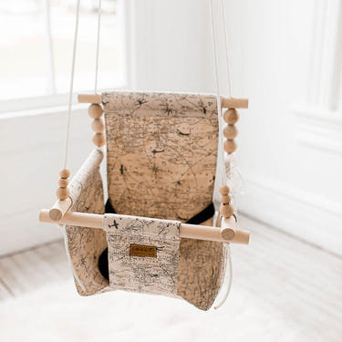 Indoor baby swing for soothing and entertaining infants, featuring a safe and comfortable design.