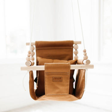 Nutmeg indoor baby swing in a cozy design, perfect for soothing and entertaining infants at home.