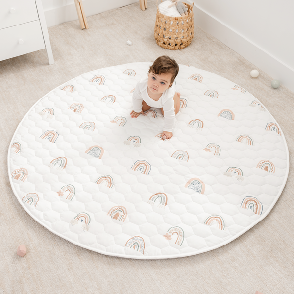 Rainbow play mat with non-slip bottom, angled view, perfect for safe and fun playtime for babies.