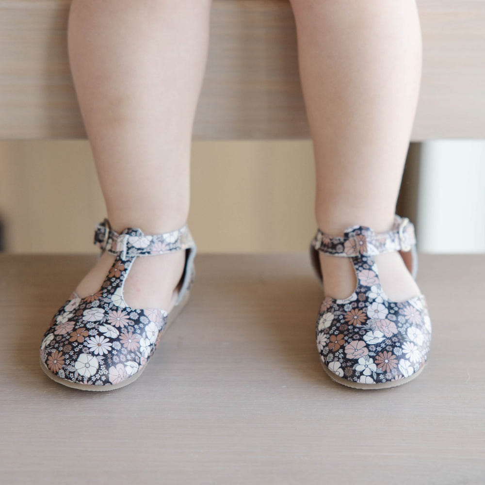 Black Floral Mary Jane Hard Sole shoes for babies, featuring a stylish design and durable construction.