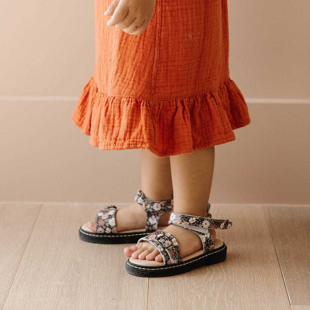 Black floral lug sole sandal for babies, perfect for stylish and comfortable summer outings.