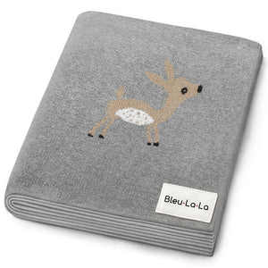 Luxury cotton deer knit swaddle baby blanket in soft colors, angled view showcasing its cozy texture and design.