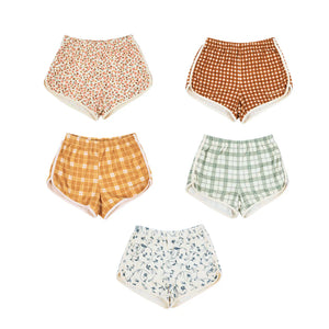 Retro organic cotton terry baby shorts in Sunset Meadow design, angle view showcasing soft fabric and vibrant colors.