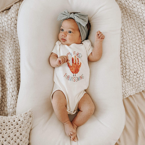 Thanksgiving-themed graphic bodysuit for babies, short sleeve, shown from angle 2. Perfect for holiday celebrations!