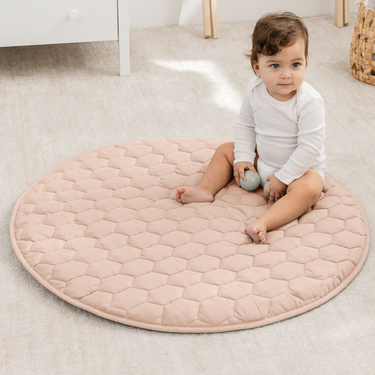 Blush play mat with non-slip bottom, perfect for safe and comfortable playtime for babies.