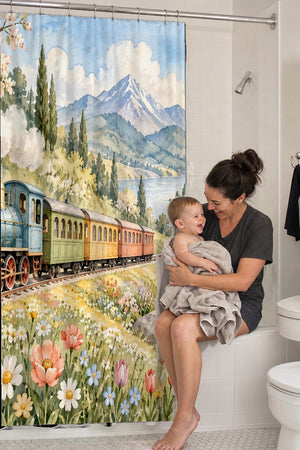 Mom holding her baby on the tub edge next to the Flower Meadow Train shower curtain