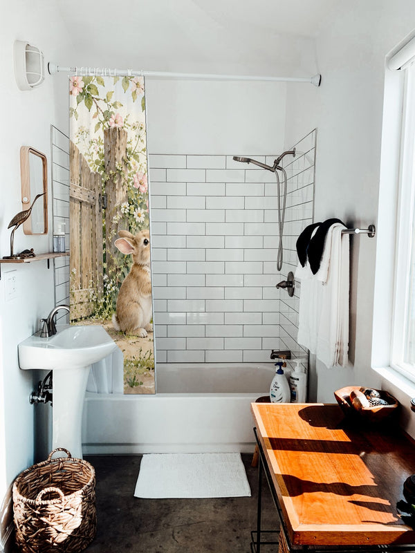 Butterfly Gate Bunny shower curtain hanging on the rod over a white bathtub