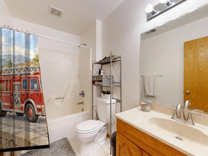 Fire Truck Town shower curtain on a tub shower combo in an American family bathroom