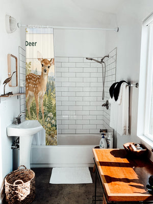 D is for Deer Alphabet shower curtain hanging on the rod over a white bathtub