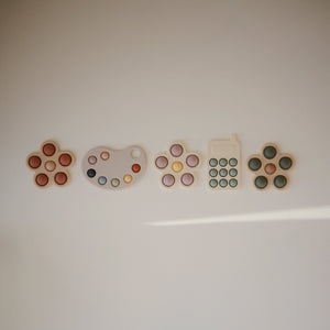 Colorful flower press toy for babies, promoting creativity and fine motor skills. Angle view showcasing vibrant design.