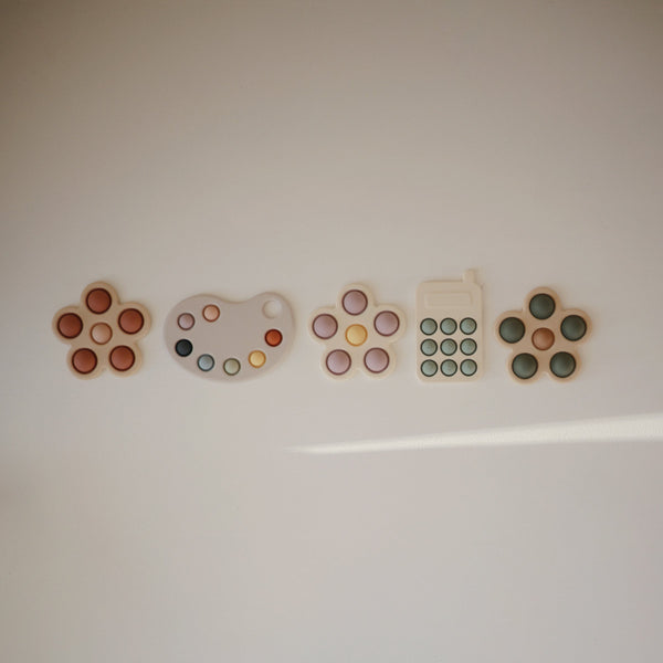 Colorful flower press toy for babies, promoting creativity and fine motor skills. Angle view showcasing vibrant design.