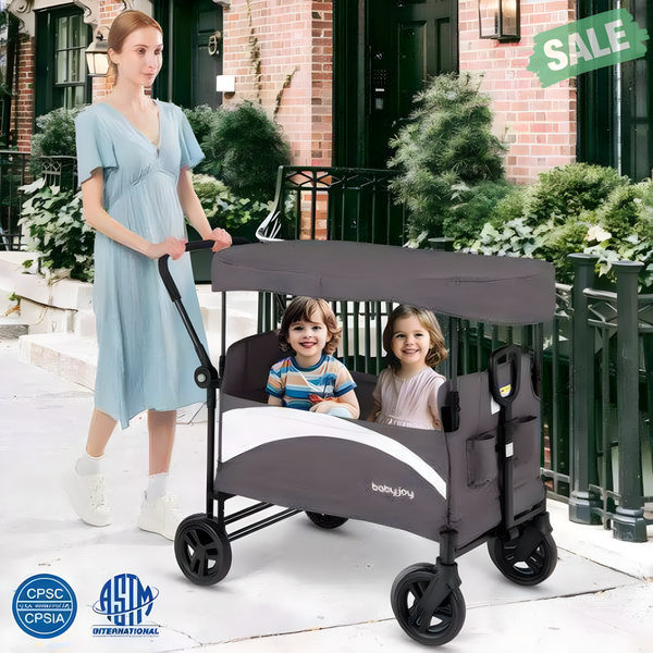Gray 2-seat stroller wagon with adjustable canopy and handles, viewed from angle 2. Perfect for outings with little ones.