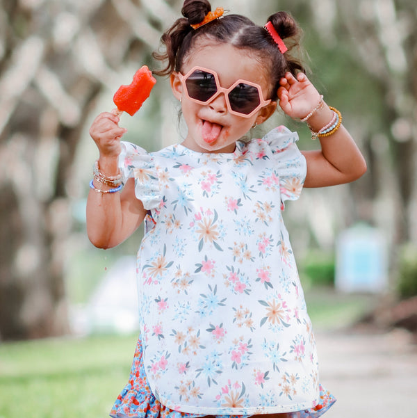 Pastel Floral Flutter Bapron for babies, angled view showcasing vibrant colors and playful design.