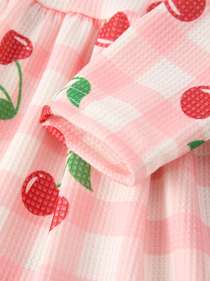 Waffle Cherry Girls Long Sleeve Dress in angle view, featuring a playful cherry print and cozy design for toddlers.