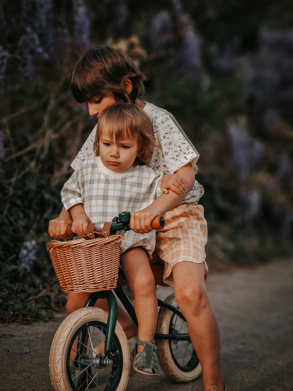 Baby swim trunks in buckwheat plaid, UPF protection, made from recycled materials, angled view.