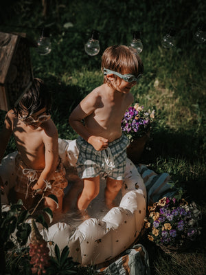 Baby swim trunks in fern plaid, UPF protected, made from recycled materials, angle view 5.