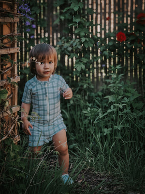Short Sleeve Rashguard Swimsuit in Fern Plaid, UPF protected, eco-friendly design for babies. Angle 8 view.