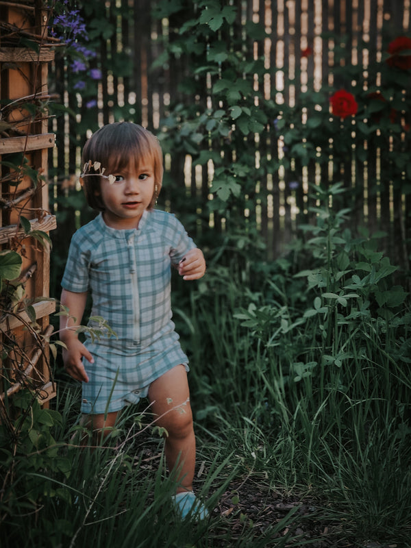 Short Sleeve Rashguard Swimsuit in Fern Plaid, UPF protected, eco-friendly design for babies. Angle 8 view.