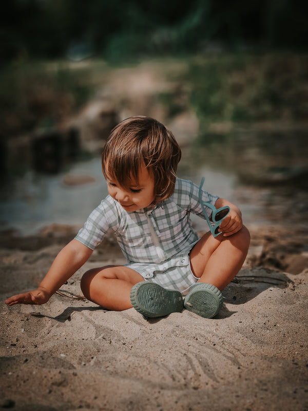 Short Sleeve Rashguard Swimsuit in Fern Plaid, UPF + Recycled material, perfect for baby beachwear.