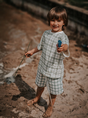 Baby swim trunks in fern plaid, UPF protection, made from recycled materials, angle 4 view.