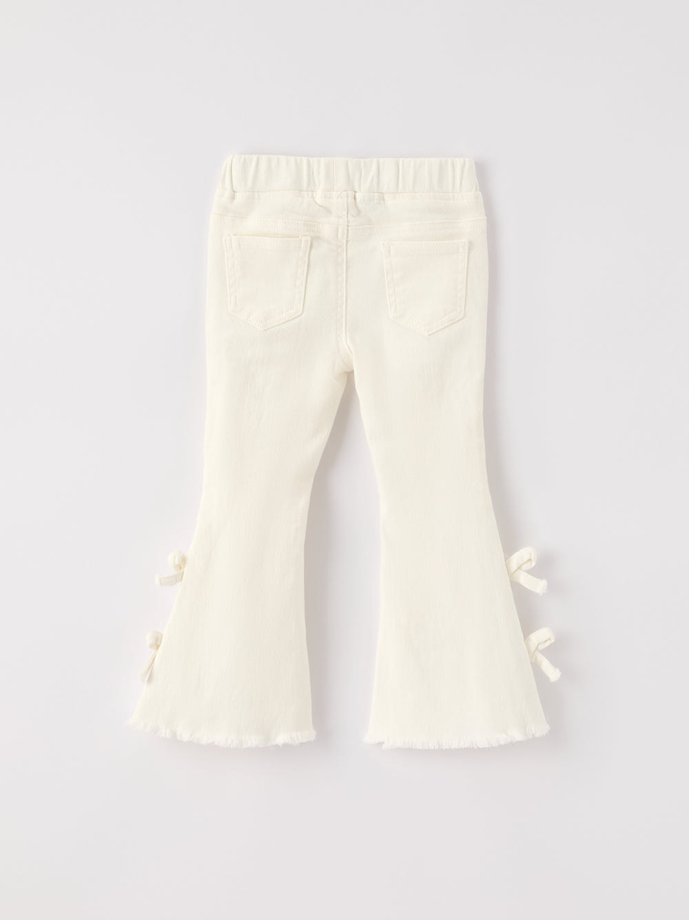Charming white denim baby pants with cute bows for fall and Christmas celebrations.