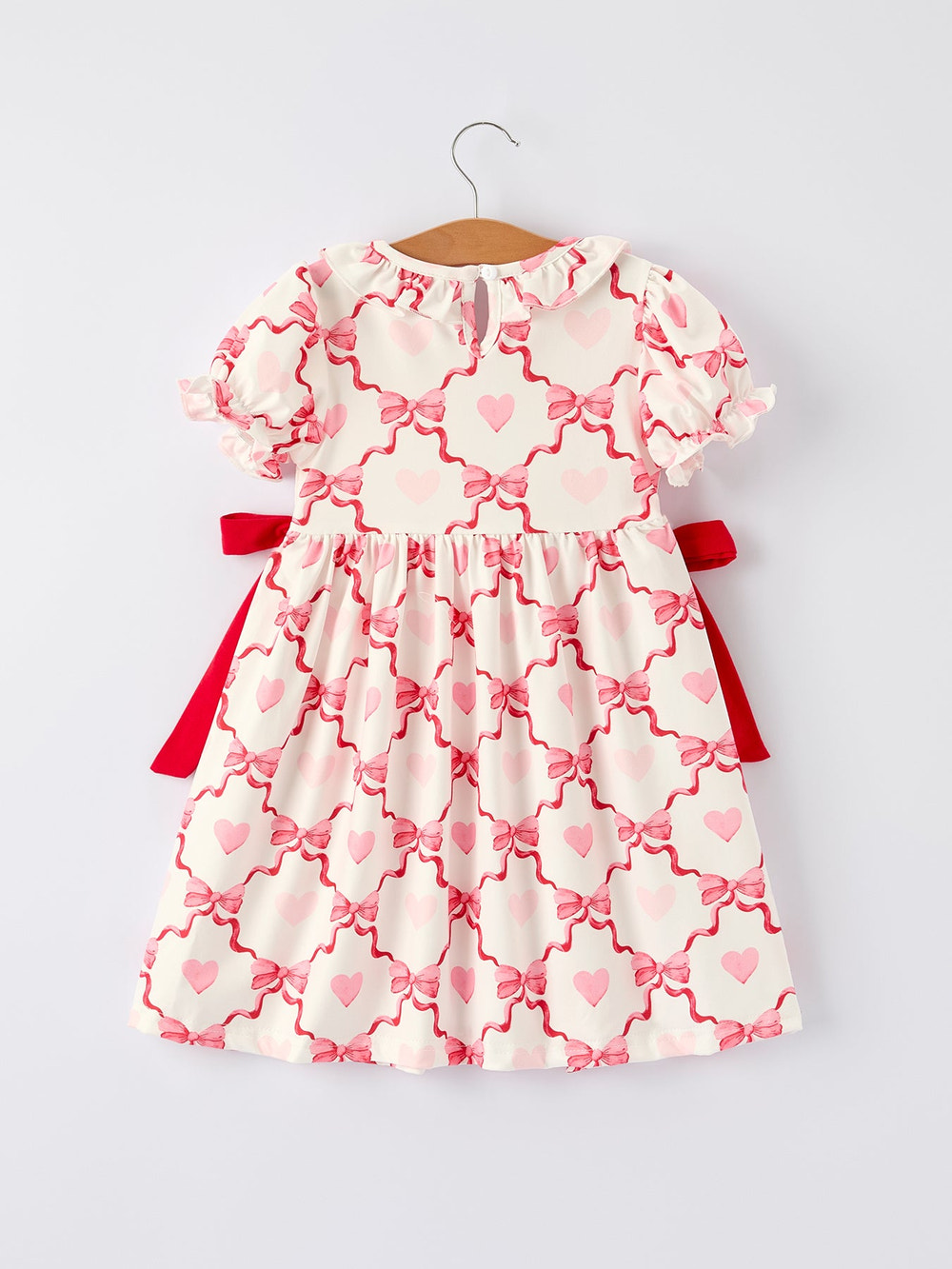 Girls Valentine dress with heart embroidery and bowknot design, perfect for special occasions.