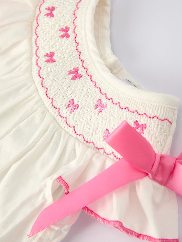Fall white baby girls romper with pink bow embroidery, angle view 3. Perfect for stylish autumn outfits.