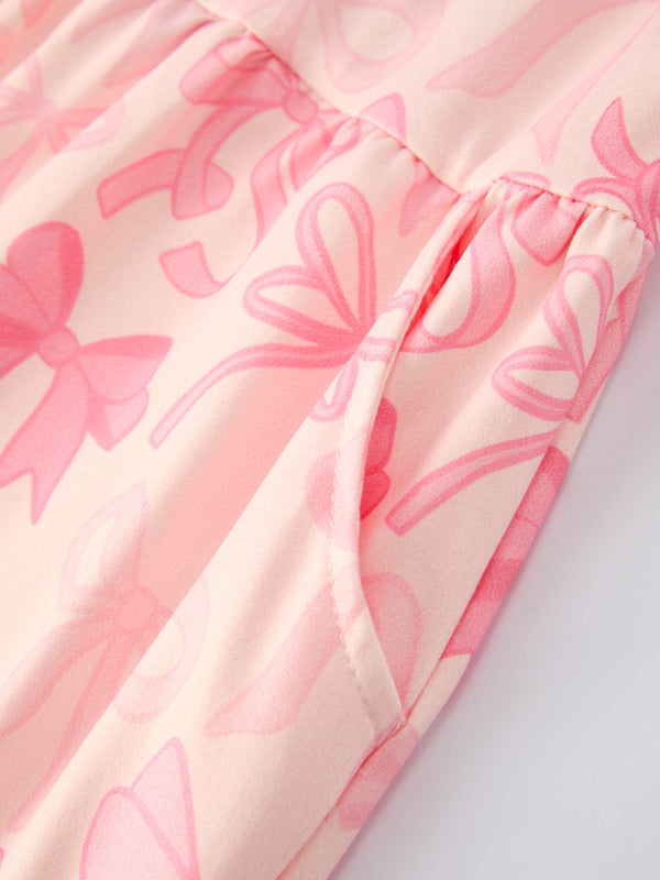 Girls pink bow print long sleeve jumpsuit, angle 3 view, perfect for stylish baby outfits.