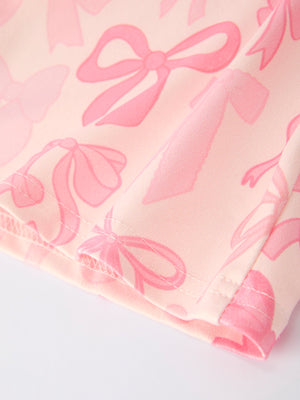 Girls pink bow print long sleeve jumpsuit, stylish and comfy for infants, shown from angle 4.