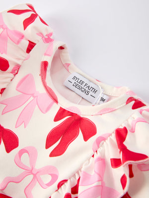 Baby girls' Valentine's bow print long sleeve ruffle romper, angle 3 view, perfect for festive occasions.