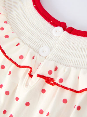 Valentine's Day polka dot girls' dress with smocking embroidery, angle view showcasing design and details.