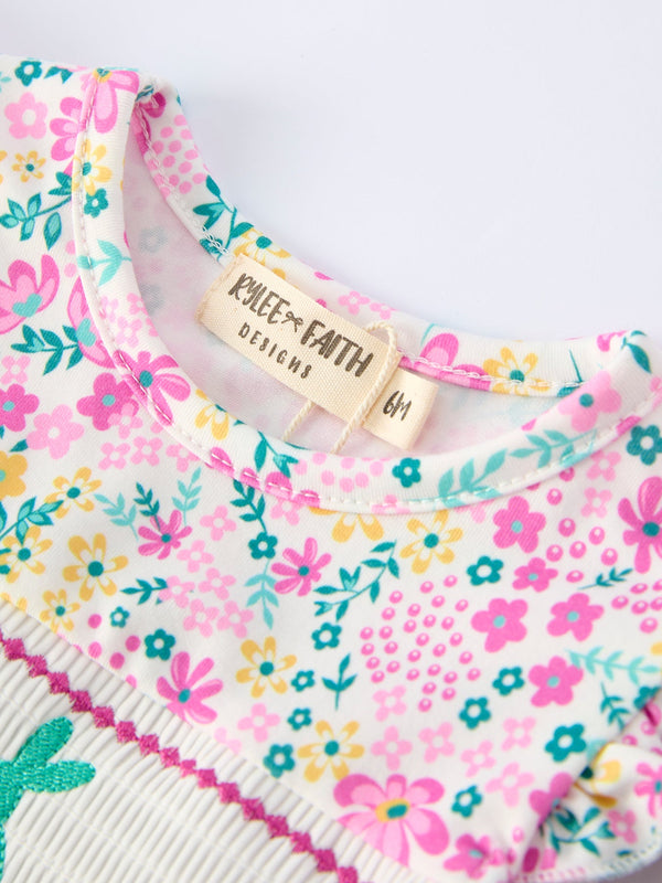 Colorful floral bunny bow romper for baby girls, featuring smocking embroidery, angle view 3. Perfect for Easter!