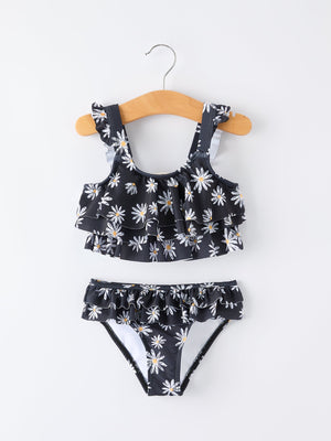 Two-piece swimsuit with floral pattern on a hanger against a white background