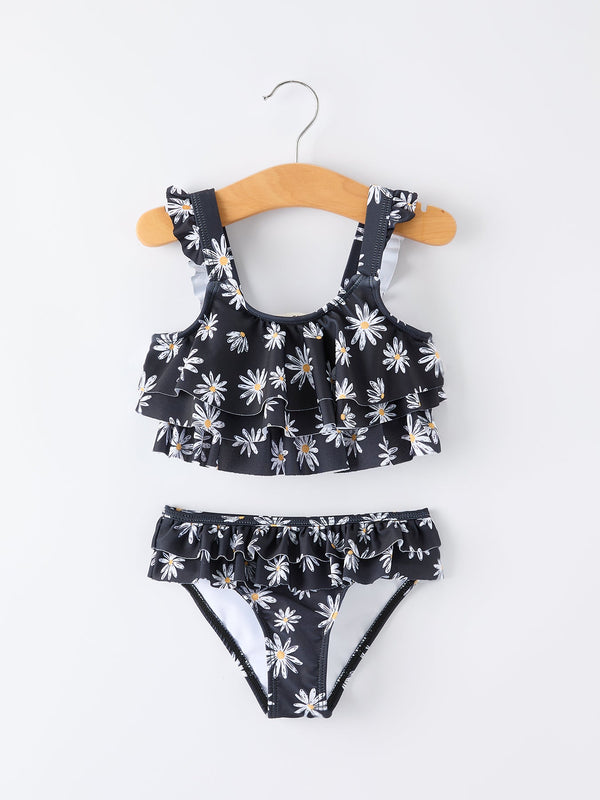Two-piece swimsuit with floral pattern on a hanger against a white background
