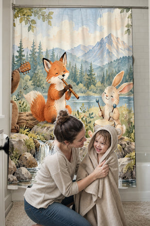 Mom drying her toddler in a hooded towel in front of the Woodland Band shower curtain
